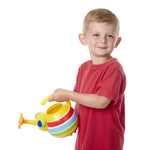 Young boy smiling and holding a yellow striped bug watering can against a white background