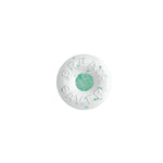Close-up of a single round Breath Savers mint with embossed branding and a green center speckled core.