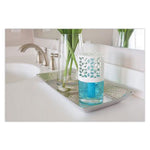 Decorative white-vented capped air freshener filled with blue liquid displayed on a bathroom tray near a faucet