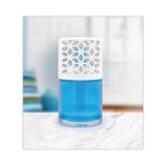 Bright blue oil in a glass air freshener topped by a white floral-patterned vented cap on a light surface