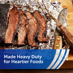 Sliced smoked brisket resting on crinkled aluminum foil on a wooden board, heavy-duty foil branding band