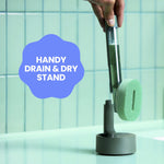 Hand lifting the Brite dishwand from its drain-and-dry stand above a tiled sink area with callout 'HANDY DRAIN & DRY STAND'