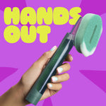 Hand holding a green Brite dishwand with foam scrubber against a purple background and yellow 'HANDS OUT' text