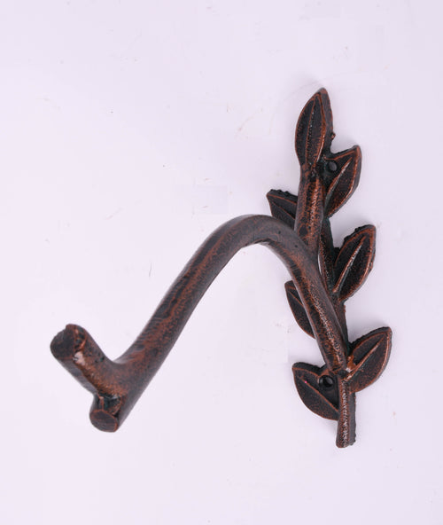 Bronzed cast-iron plant bracket with curved arm and decorative leaf-pattern mounting plate on white background