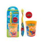 Sesame Street themed kids toothbrush set with yellow toothbrush, orange rinse cup, and red travel cap shown with retail blister packaging