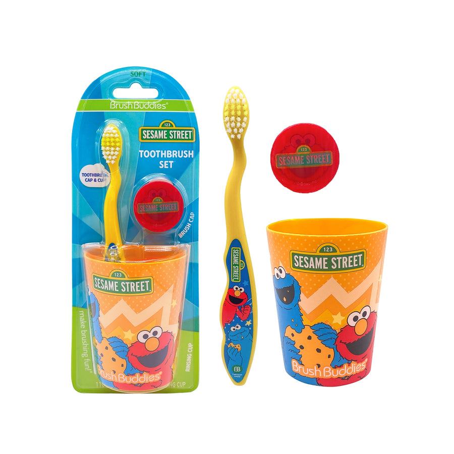 Sesame Street themed kids toothbrush set with yellow toothbrush, orange rinse cup, and red travel cap shown with retail blister packaging