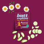 Maroon Butt Napkins sachet styled with chamomile flowers and sliced cucumbers on a matching background
