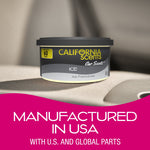 California Scents 'Ice' air freshener can resting on a beige car seat, shown with a pink banner stating manufacturing text.