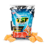 Silver pouch of Camco TST Max RV toilet treatment with scattered orange citrus drop-in pods visible in front