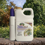 Captain Jack's Neem MAX jug with purple spray wand set on a garden edging with plants and hedges in background