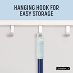 Top of broom handle with textured hanging hook branded Casabella shown suspended from an over-door hook with headline