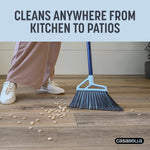 Casabella broom sweeping cereal pieces on wood floor with person’s legs visible and headline about cleaning anywhere