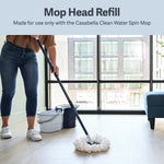 Person mopping a floor with a Casabella spin mop and white refill head near a two-bucket system