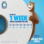 Large close-up toilet paper roll with Charmin bear mascot and graphic claiming up to one week before changing the roll