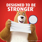 Bear mascot holding a textured sheet of Charmin Ultra Strong toilet paper with magnified diamond-weave inset