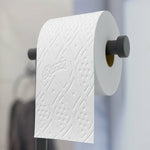 Single Charmin toilet paper roll on a wall-mounted holder showing embossed Charmin pattern and texture.