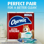 Charmin Ultra Strong mega roll pack staged in bathroom scene with bear mascot and a pack of Charmin wipes in front.