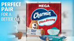 Lifestyle-style image of Charmin Ultra Strong Mega pack next to folded towels and a pack of Charmin wipes