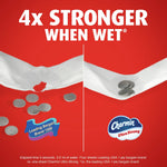Comparison graphic showing two strips of toilet paper on red background with text '4x STRONGER WHEN WET' and Charmin logo