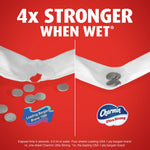 Split comparison showing coins on torn versus intact wet sheets with text '4x stronger when wet' and Charmin Ultra Strong logo