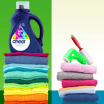 Cheer colorguard detergent bottle beside stacked colorful folded clothes and laundry tools on split green background