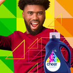 Smiling man with colorful geometric background and a cheer colorguard detergent bottle in foreground
