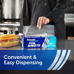 Chef in black coat dispensing a pre-cut sheet from a Reynolds Foodservice foil sheets box on a stainless counter