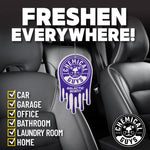 Purple Chemical Guys Galactic Scent hanging air freshener suspended between car seats with copy promoting freshness everywhere.