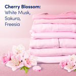 Stack of folded pink laundry with cherry blossoms and text listing scent notes for Cherry Blossom