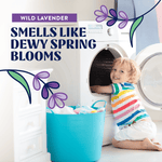 Child playing at an open washing machine next to a laundry basket with text declaring wild lavender scent and floral graphics