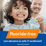 Child brushing teeth with a green toothbrush and overlay text highlighting that the product is fluoride-free and safe if swallowed
