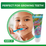 Smiling child brushing teeth beside a tube of Brush Buddies Crayola Swirl toothpaste with ‘Perfect for growing teeth’ header