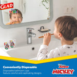 Child brushing teeth at a sink with two Glad Disney Minnie Mouse paper bath cups visible on the counter.