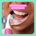 Close lifestyle image of a child brushing teeth with a Frida electric toothbrush showing foamy mouth and soft bristles