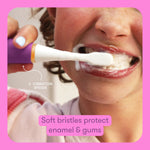Child using a purple electric toothbrush in mouth, foam visible on teeth, with overlay text noting soft bristles and 2 vibration speeds.