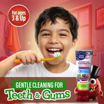 Smiling child brushing teeth with GuruNanda Kids toothpaste visible in foreground and 'gentle cleaning for teeth & gums' banner