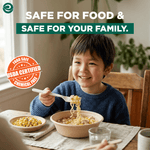 Child at a table smiling while using an EcoSoul compostable fork to eat noodles with a USDA certified food-safe badge overlay.