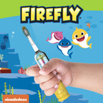 Close-up of a child holding a Firefly Baby Shark toothbrush against a blue ocean graphic background