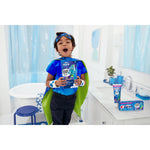 Child in a bathroom holding an Oral‑B kids toothbrush box, bathroom counter displays Crest toothpaste and Oral‑B products in background.