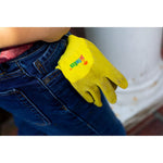 Child wearing a yellow-green gardening glove tucked into a jeans pocket, glove shows JustForKids branding