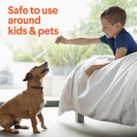 Boy on a bed reaching toward a sitting dog with overlay text “Safe to use around kids & pets” on a bright background.