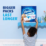 Lifestyle-style marketing image of a child reaching for a Charmin Ultra Soft multi-roll pack on a shelf