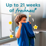Child holding a blue shirt to their face with floating flowers and text reading “Up to 21 weeks of freshness” overlaid.
