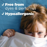 Child peeking from under bedding with overlay text listing Free from dyes & perfumes and Hypoallergenic