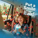 Smiling child in a car seat holding a blue slushy with raspberries floating around, promotional lifestyle image for scent.