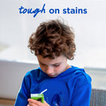 Child wearing a blue sweatshirt with a visible stain and headline text reading 'tough on stains'