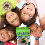 Overhead lifestyle image of smiling children in a circle with a Shubug pouch placed in the center foreground.