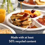 Served breakfast with pancakes, syrup and fruit on a Chinet white three-compartment disposable plate in a styled tabletop scene.