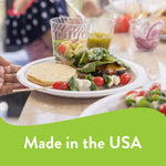 Chinet white paper plate holding a burger and salad on a table with clear glassware and 'Made in the USA' banner
