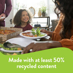 Family-style scene with people serving pizza and salad on Chinet white plates at a dining table, with green recycled-content banner.